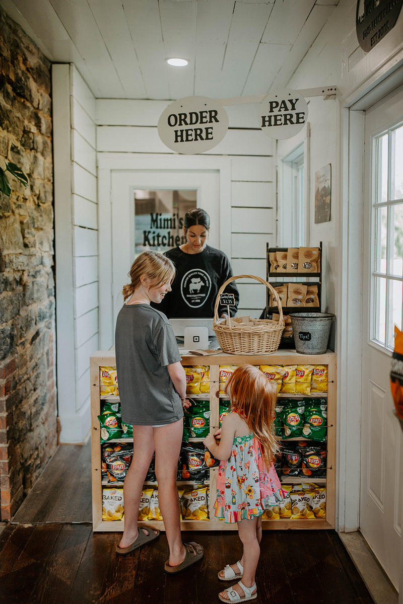 Inside DMD General Store with family shopping local goods