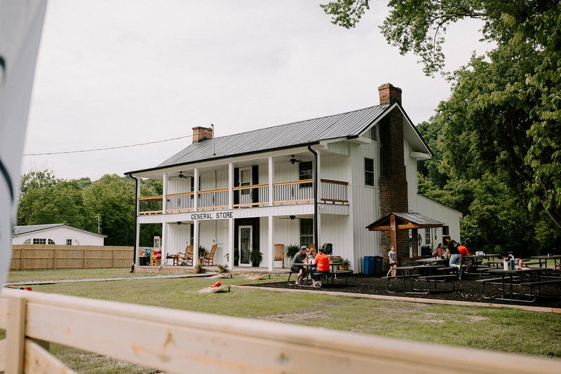 Outdoor seating and picnic tables at DMD General Store in Midway TN